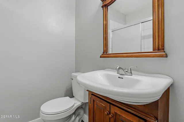 a bathroom with a sink a toilet and mirror