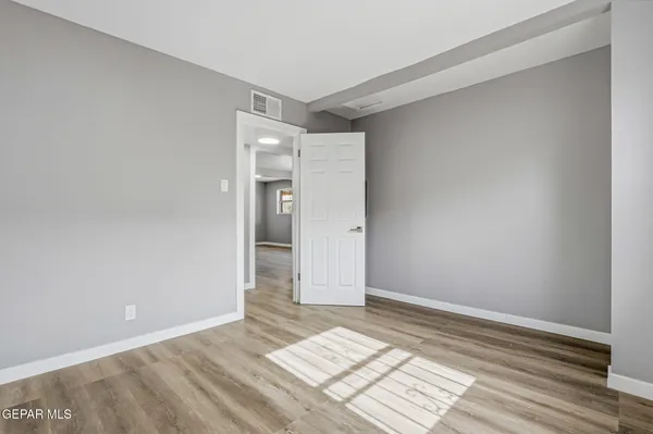 a view of an empty room and wooden floor