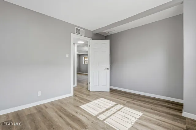 a view of an empty room and wooden floor