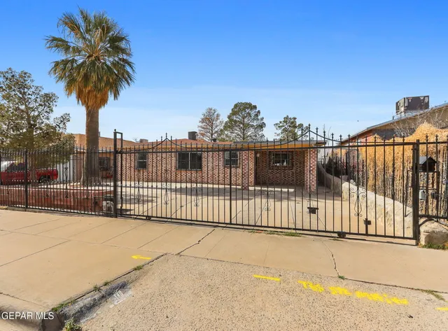 a view of a balcony with a floor to ceiling window and palm tree