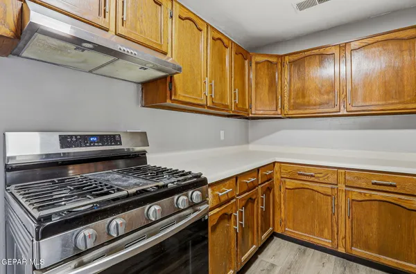 a kitchen with stainless steel appliances granite countertop a stove and a cabinets