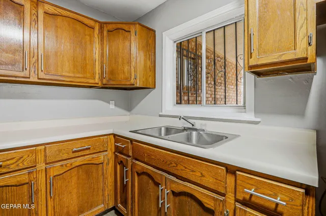 a kitchen with a sink and cabinets