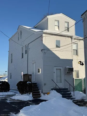 a black and white building with black door