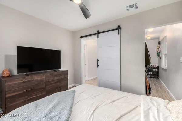 a bedroom with a bed and a flat screen tv