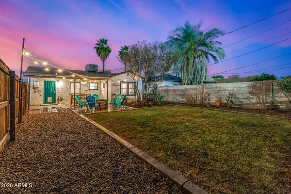 a view of a backyard with a table and chair
