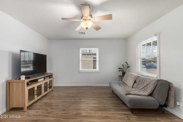 a kitchen with stainless steel appliances granite countertop a sink and cabinets with wooden floor