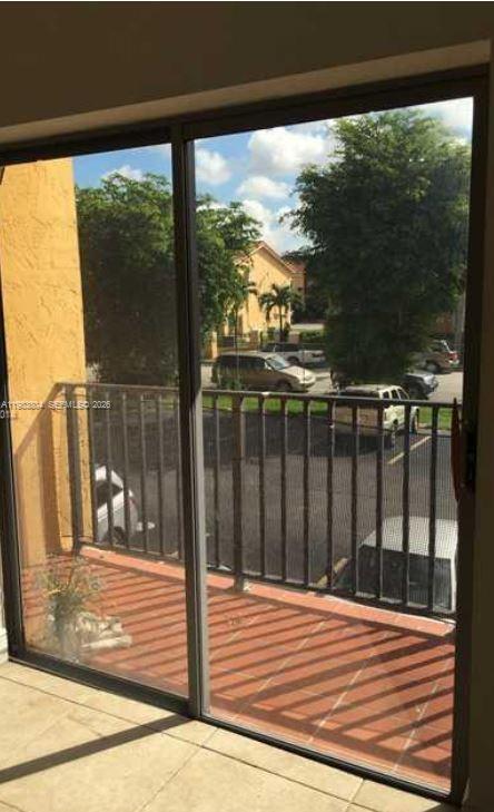 a view of a balcony with a floor to ceiling window wooden floor