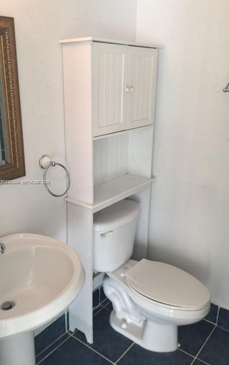 4705 Northwest 7th Street, Unit 2057 Miami, FL 33126 - Photo 5 of 9 a white toilet sitting next to a bathroom sink