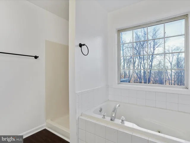 a white bath tub sitting next to a window