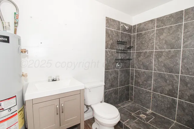 a bathroom with a sink toilet and shower