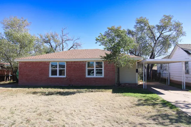 a house that has a tree in front of it
