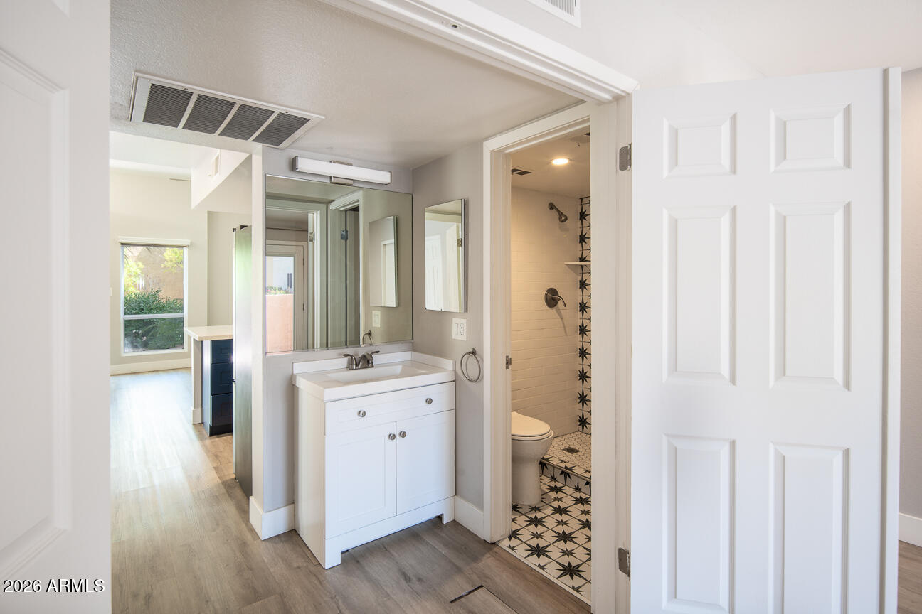4540 North 44th Street, Unit 50 Phoenix, AZ 85018 - Photo 9 of 31 a spacious bathroom with a shower a sink and a mirror