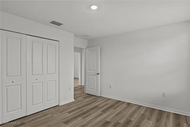 a view of an empty room and wooden floor