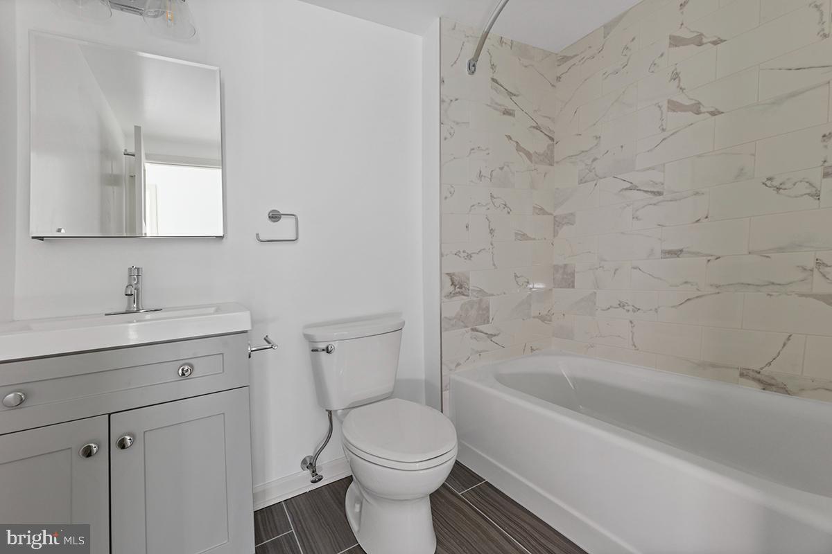 404 Fountain Street, Unit 406 Philadelphia, PA 19128 - Photo 9 of 10 a bathroom with a sink toilet and shower