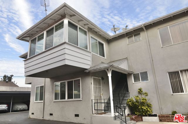 a front view of a house with parking space