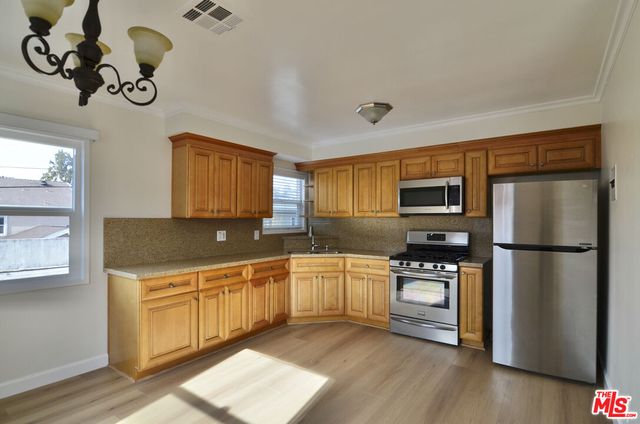 a kitchen with a refrigerator and a sink