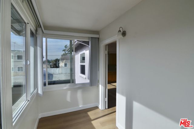 a view of a hallway with a glass door and a glass door