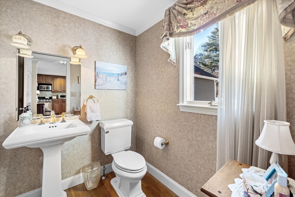 55 Bay Farm Road, Unit 55 Duxbury, MA 02332 - Photo 14 of 37 a bathroom with a toilet a sink and a mirror