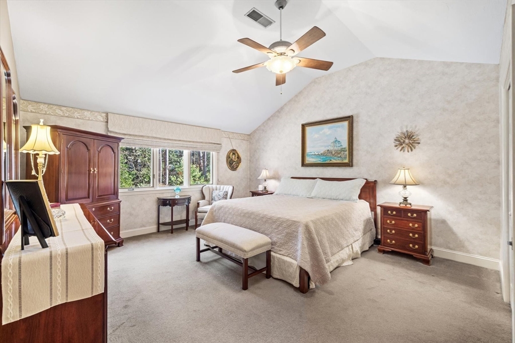 55 Bay Farm Road, Unit 55 Duxbury, MA 02332 - Photo 17 of 37 a spacious bedroom with a bed and a chandelier