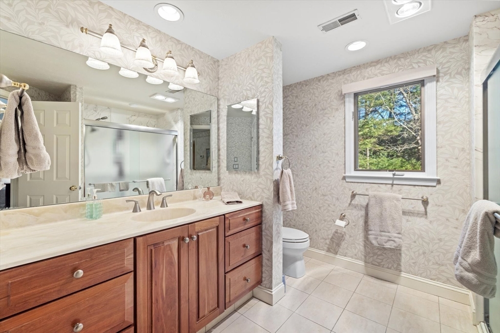 55 Bay Farm Road, Unit 55 Duxbury, MA 02332 - Photo 19 of 37 a spacious bathroom with a double vanity sink a toilet a mirror and a shower
