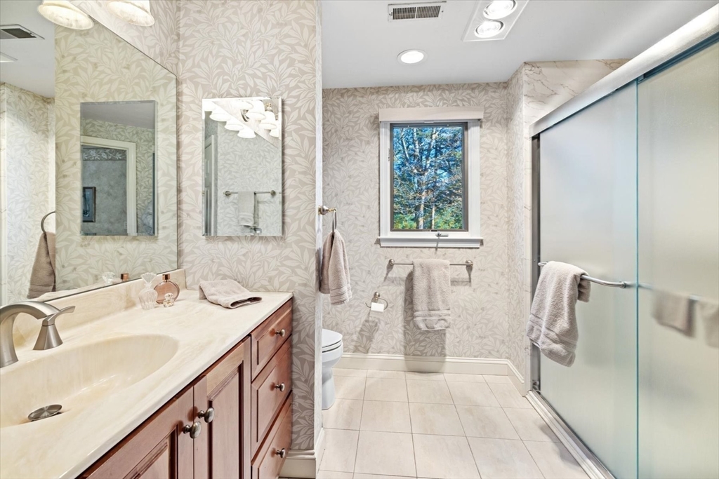 55 Bay Farm Road, Unit 55 Duxbury, MA 02332 - Photo 20 of 37 a bathroom with a double vanity sink a mirror and a bathtub