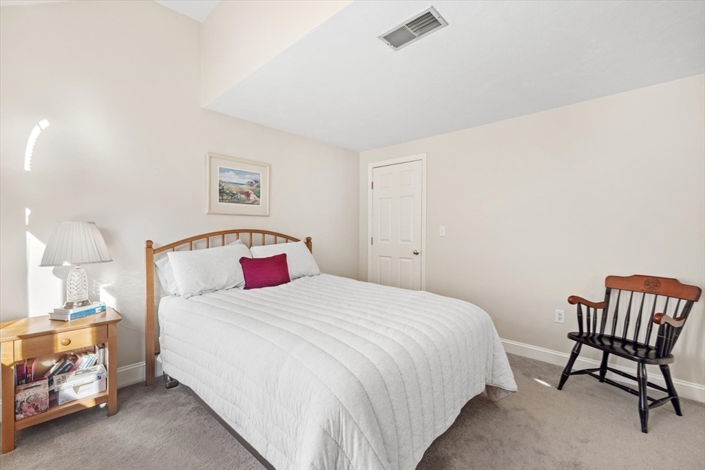 55 Bay Farm Road, Unit 55 Duxbury, MA 02332 - Photo 23 of 37 a bedroom with a bed and a chair