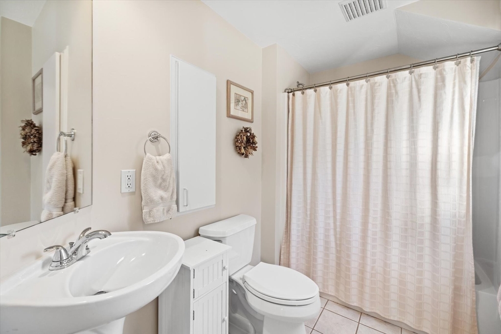 55 Bay Farm Road, Unit 55 Duxbury, MA 02332 - Photo 24 of 37 a bathroom with a sink a toilet and shower curtain