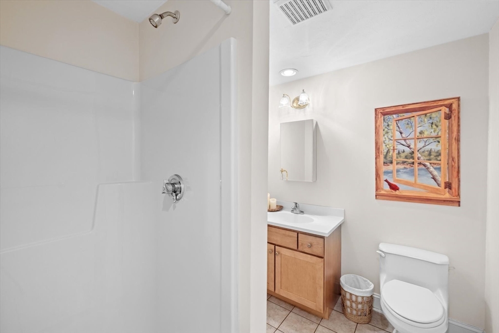 55 Bay Farm Road, Unit 55 Duxbury, MA 02332 - Photo 27 of 37 a bathroom with a toilet sink vanity and mirror