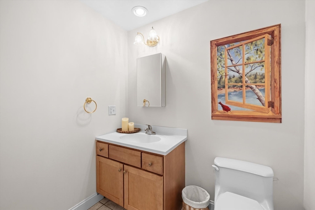 55 Bay Farm Road, Unit 55 Duxbury, MA 02332 - Photo 28 of 37 a bathroom with a toilet a sink and mirror