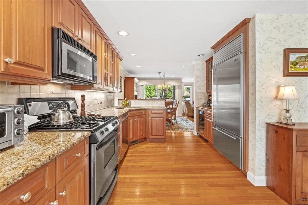 55 Bay Farm Road, Unit 55 Duxbury, MA 02332 - Photo 3 of 37 a kitchen with stainless steel appliances granite countertop lots of counter top space and wooden floor