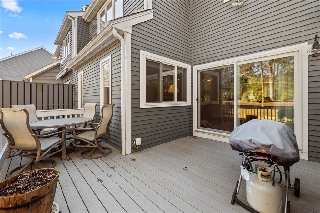 55 Bay Farm Road, Unit 55 Duxbury, MA 02332 - Photo 5 of 37 a view of a deck with table and chairs with wooden floor and furniture