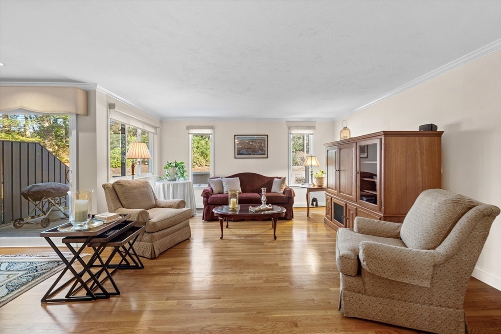55 Bay Farm Road, Unit 55 Duxbury, MA 02332 - Photo 6 of 37 a living room with furniture and a fireplace