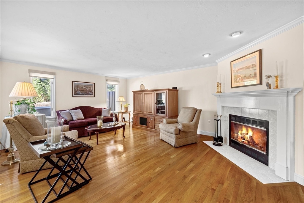 55 Bay Farm Road, Unit 55 Duxbury, MA 02332 - Photo 7 of 37 a living room with furniture and a fireplace