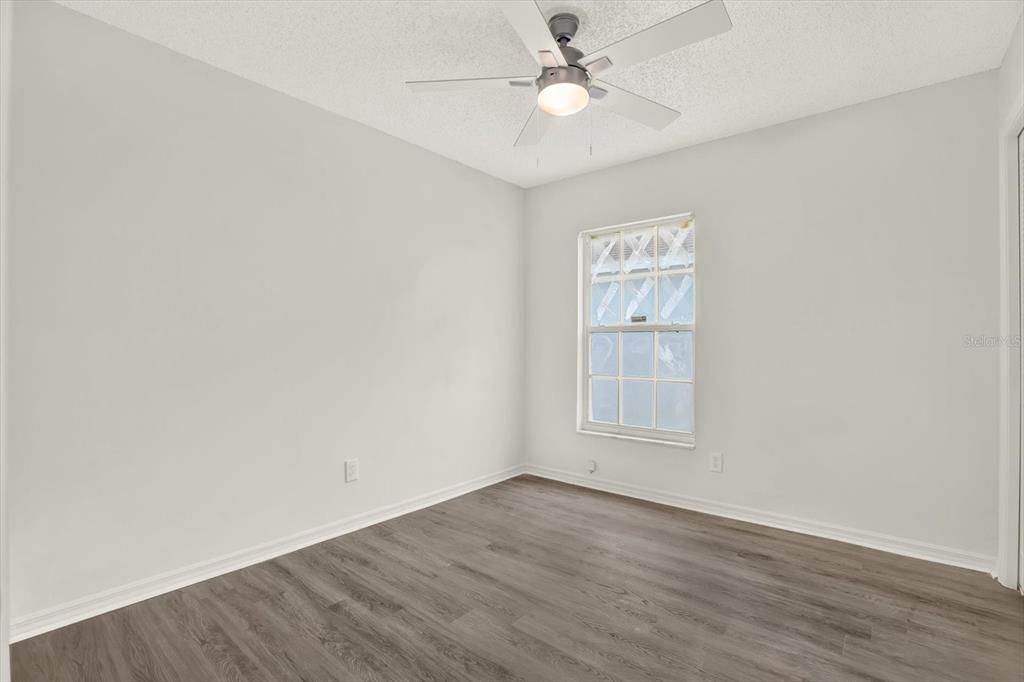 1712 Elk Spring Drive Brandon, FL 33511 - Photo 13 of 21 an empty room with wooden floor window and ceiling fan
