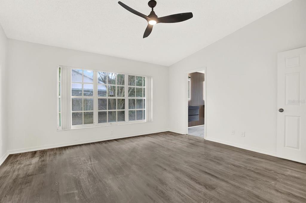 1712 Elk Spring Drive Brandon, FL 33511 - Photo 15 of 21 a view of an empty room with a window and wooden floor