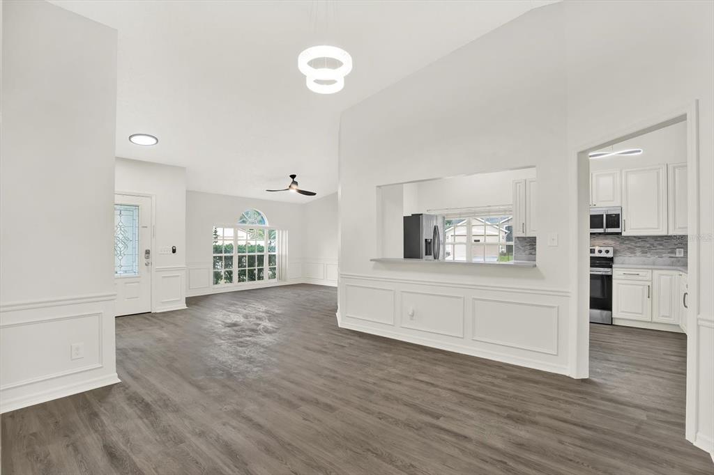 1712 Elk Spring Drive Brandon, FL 33511 - Photo 5 of 21 a view of a big room with wooden floor and windows