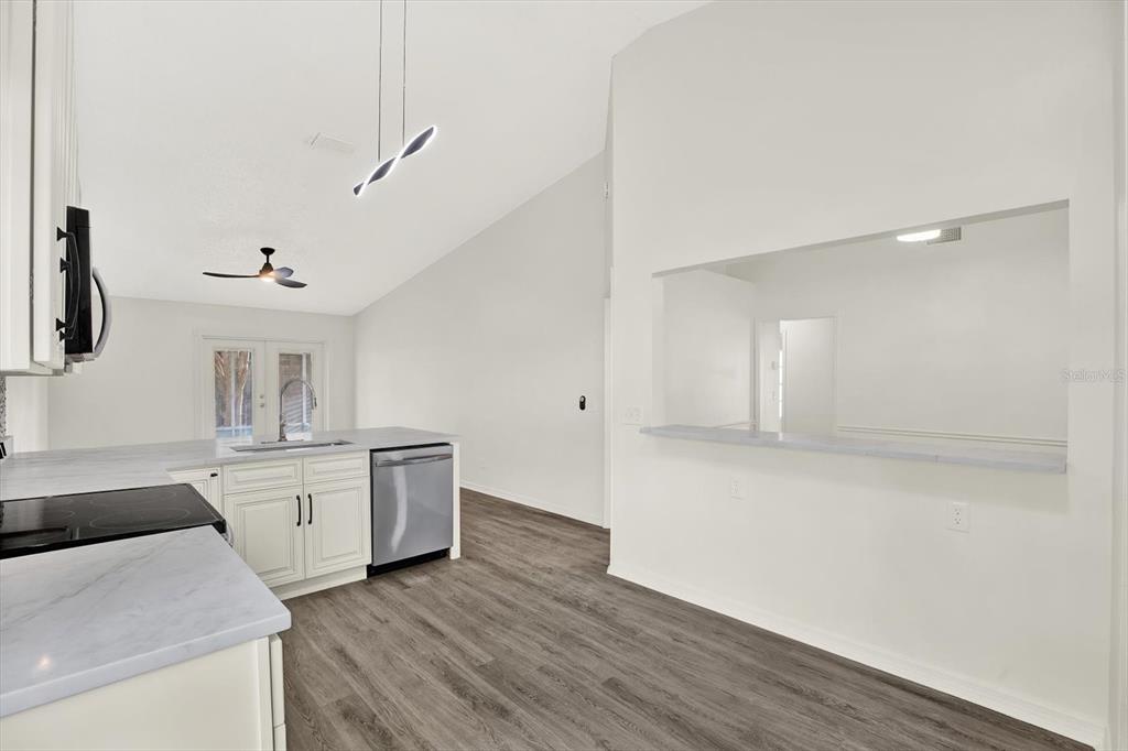 1712 Elk Spring Drive Brandon, FL 33511 - Photo 8 of 21 a kitchen with granite countertop a sink cabinets and wooden floor