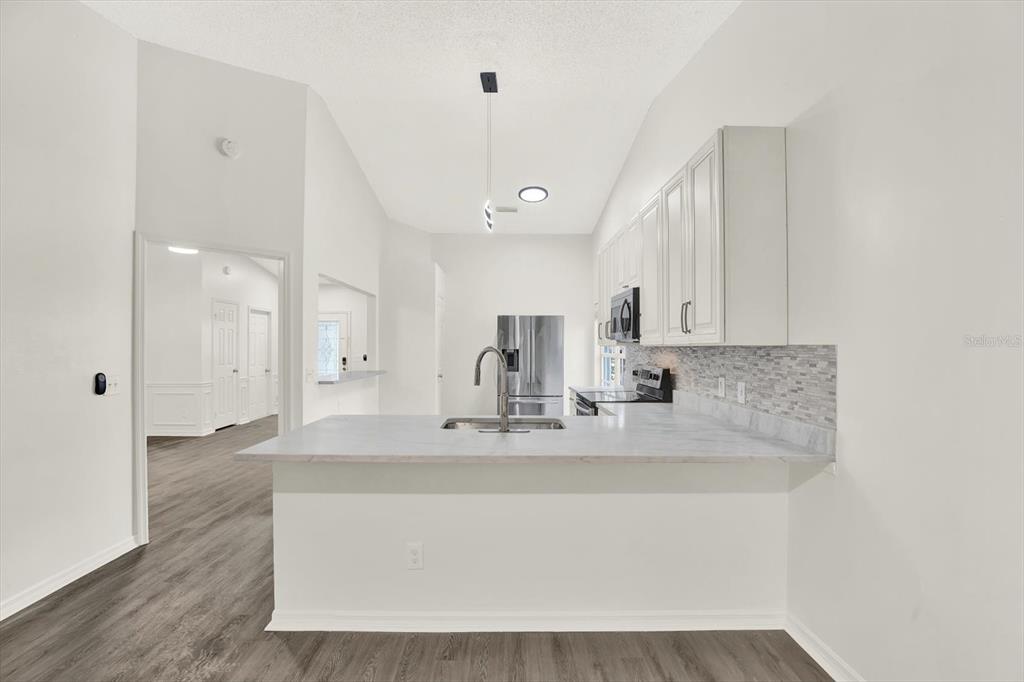 1712 Elk Spring Drive Brandon, FL 33511 - Photo 9 of 21 a bathroom with a sink a mirror and shower