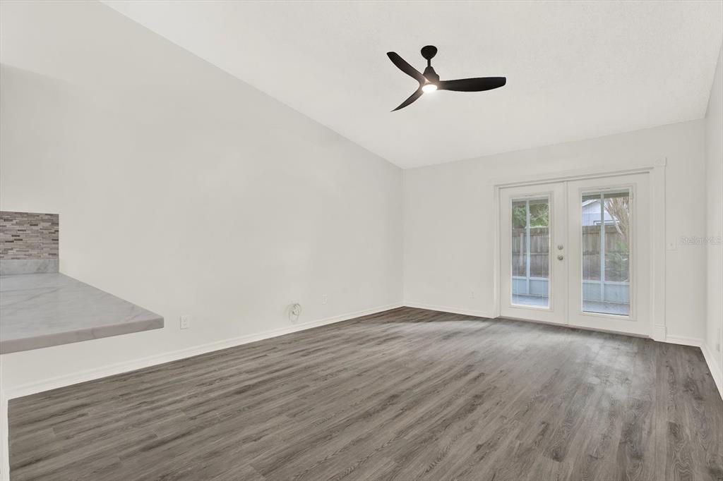 1712 Elk Spring Drive Brandon, FL 33511 - Photo 10 of 21 wooden floor in an empty room with a window