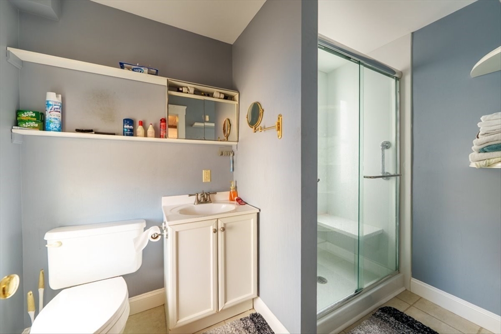 95 Lake Street Webster, MA 01570 - Photo 12 of 40 a bathroom with a sink a toilet and a mirror