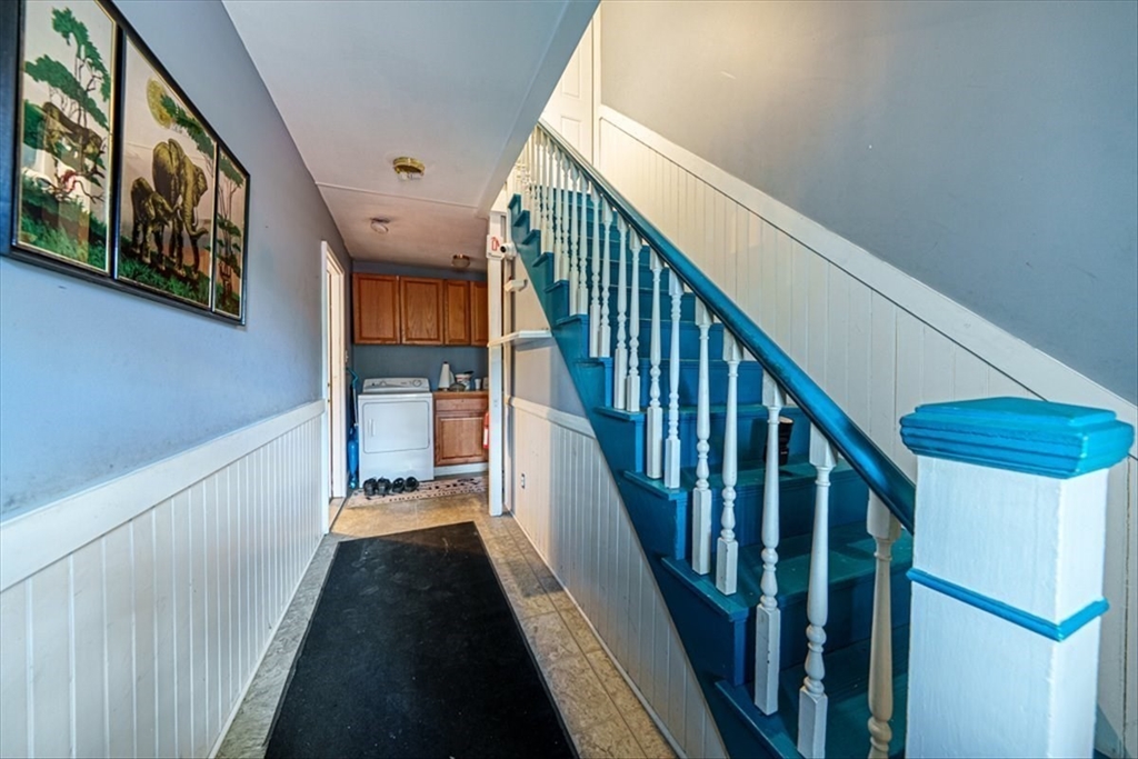 95 Lake Street Webster, MA 01570 - Photo 14 of 40 a view of staircase with lots of frames on wall and a window
