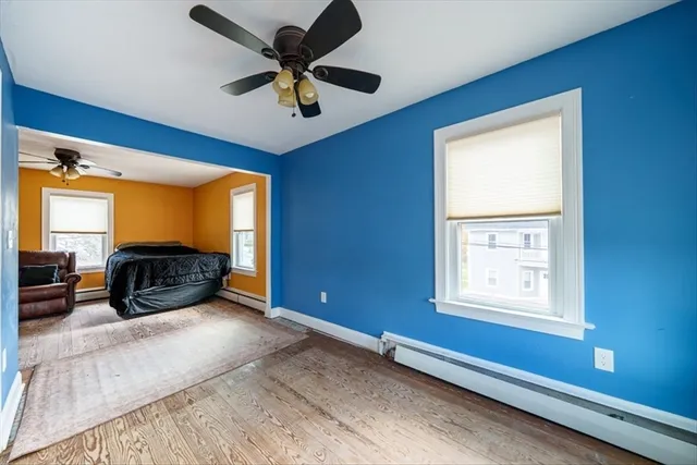 a bedroom with furniture and a large window
