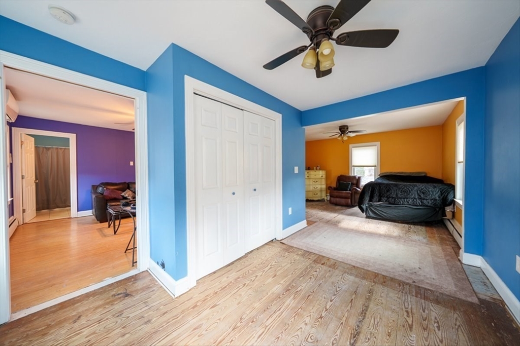 95 Lake Street Webster, MA 01570 - Photo 16 of 40 a bedroom with a bed and a chandelier