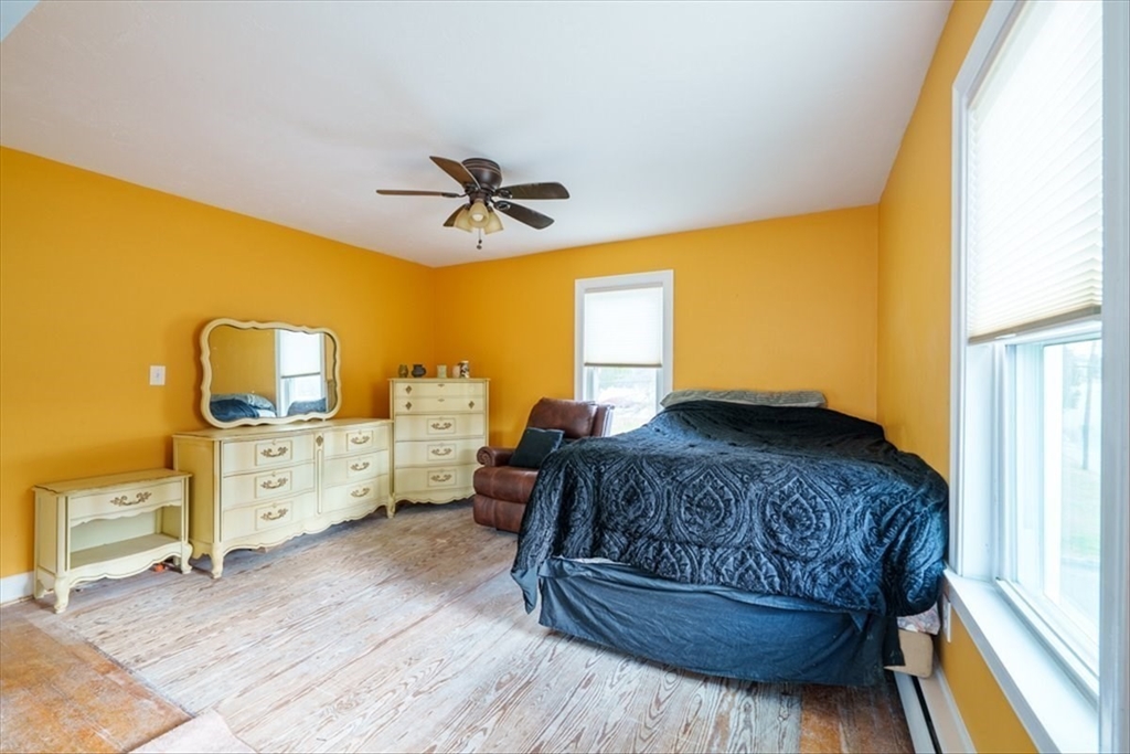 95 Lake Street Webster, MA 01570 - Photo 17 of 40 a spacious bedroom with a bed and wooden floor