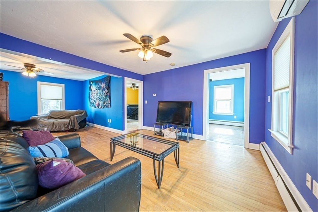 95 Lake Street Webster, MA 01570 - Photo 20 of 40 a living room with furniture a fireplace and a flat screen tv