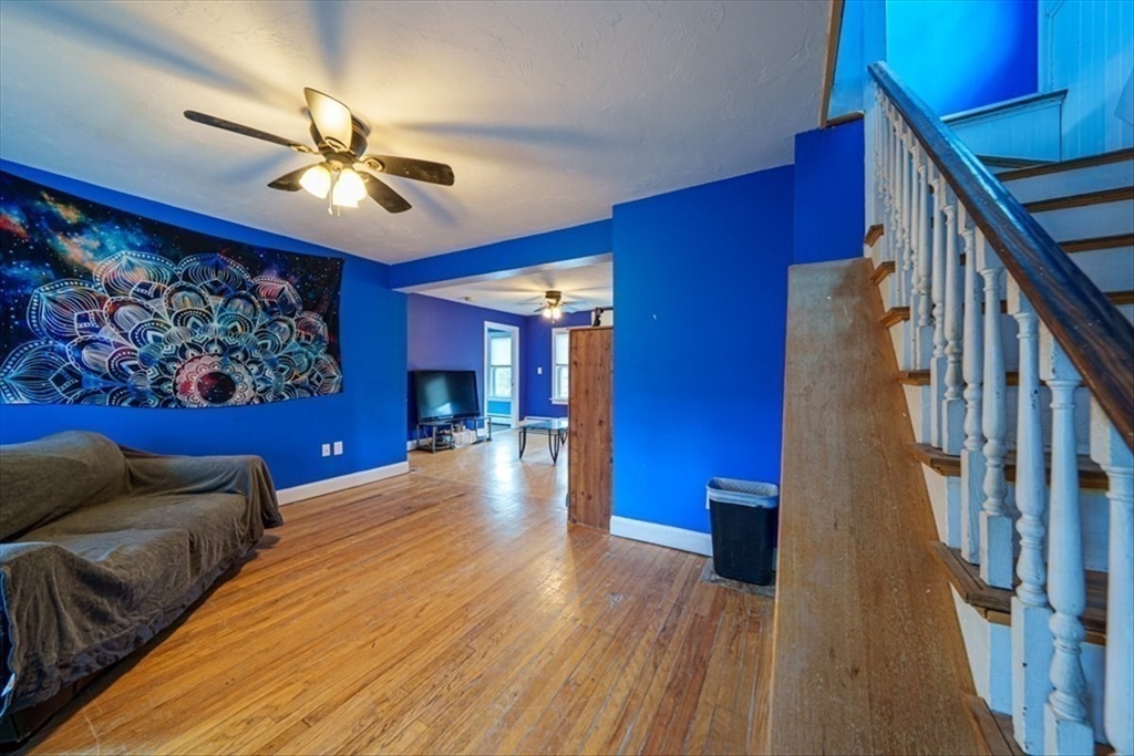 95 Lake Street Webster, MA 01570 - Photo 23 of 40 a view of a livingroom with furniture chandelier fan and wooden floor
