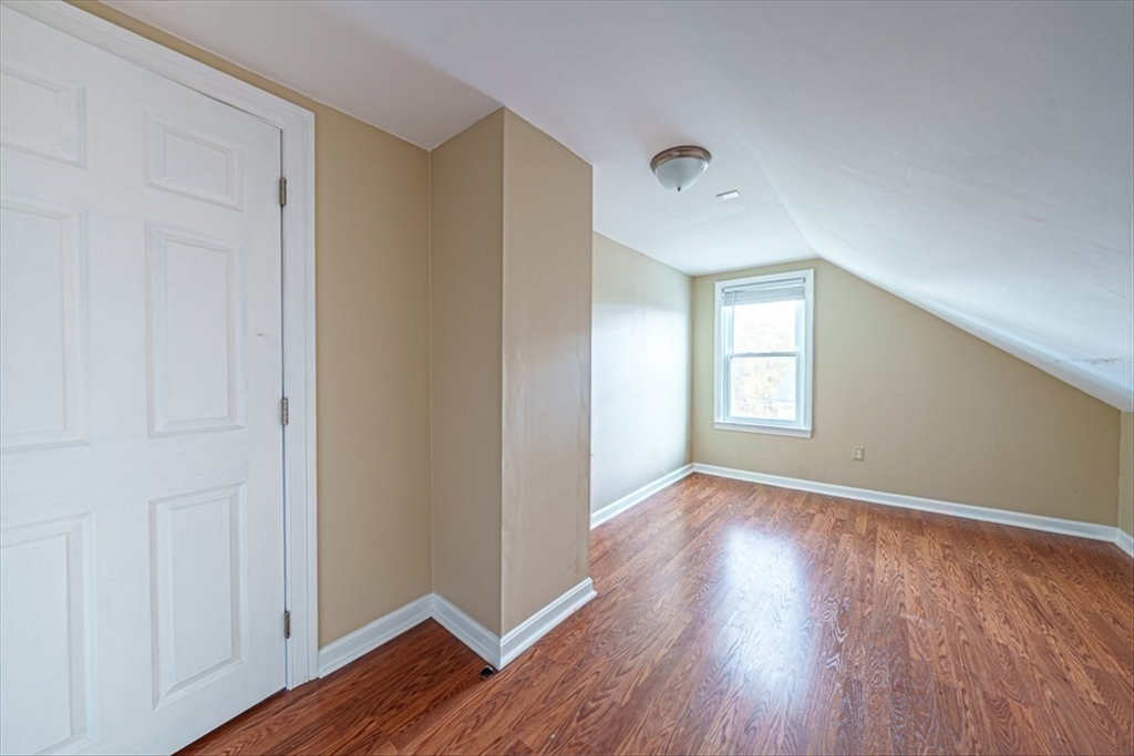 95 Lake Street Webster, MA 01570 - Photo 30 of 40 a view of an empty room with window and wooden floor