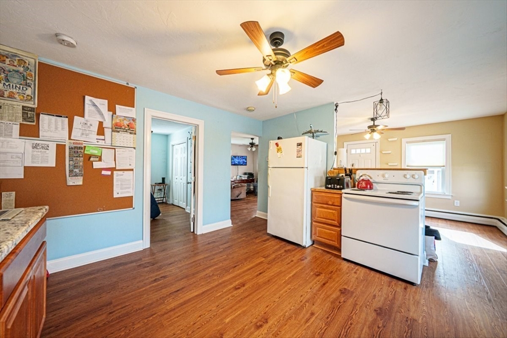 95 Lake Street Webster, MA 01570 - Photo 9 of 40 a kitchen with a refrigerator and wooden floor