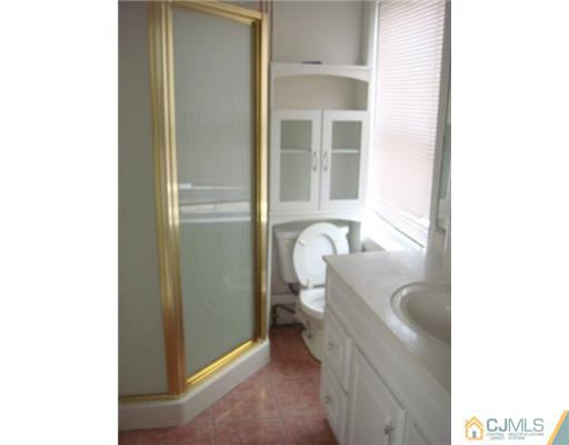 348 Front Street Dunellen, NJ 08812 - Photo 8 of 15 a bathroom with a sink and a toilet