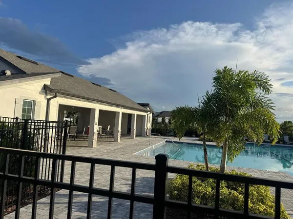 a view of a house with backyard and balcony